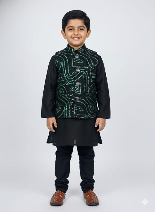 Young boy wearing a black kurta with a green embroidered jacket on a white background