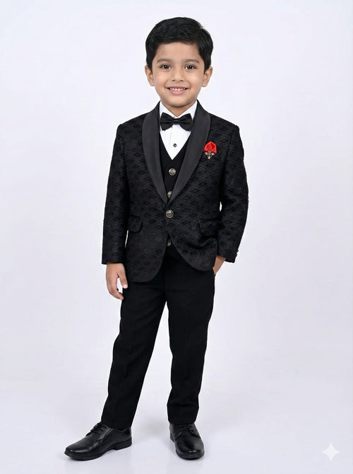 Young boy in a formal black suit with a red flower on a white background