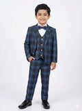 Young boy wearing a blue checkered suit with a bow tie on a white background