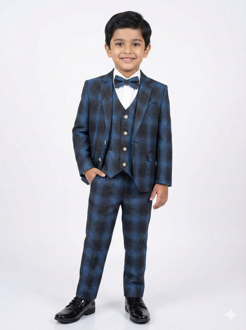 Young boy wearing a blue checkered suit with a bow tie on a white background