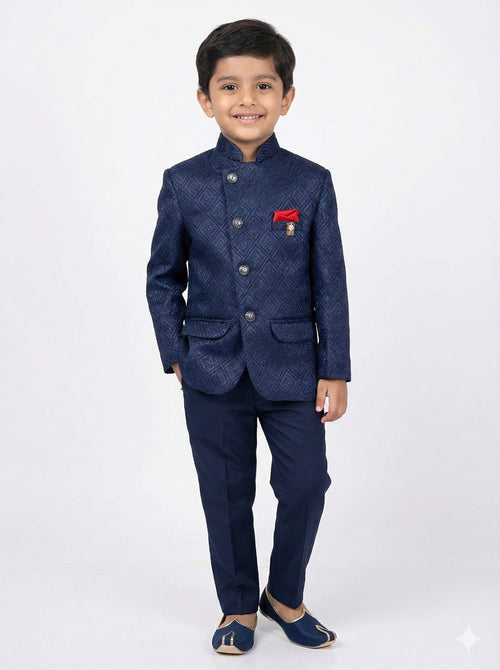 Young boy wearing a navy blue suit with a red pocket square on a white background