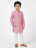 Child wearing a pink kurta with white pants on a white background