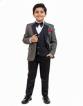 Young boy in a formal suit with a bow tie on a white background
