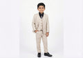 Young boy wearing a beige suit with a white background