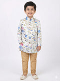 Child wearing a floral kurta with beige pants on a white background