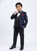 Young boy in a formal black and blue suit with a white shirt and bow tie on a white background