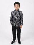Young boy wearing a black and gray patterned suit on a white background