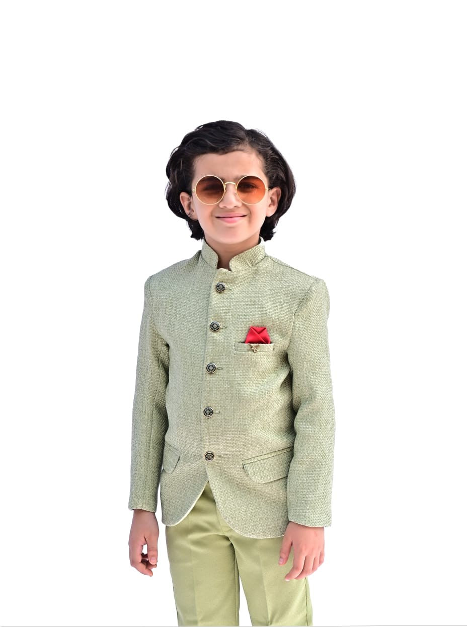 Child wearing a light green traditional jacket with a red pocket square on a white background
