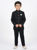 Young boy wearing a black formal suit on a white background