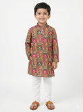 Child wearing a traditional patterned kurta with white pants on a white background