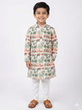 Child wearing a patterned kurta with white pants on a white background