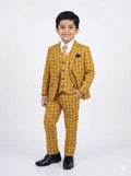 Young boy wearing a yellow checkered suit on a white background