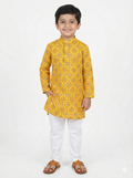 Child wearing a yellow kurta with white pants on a white background