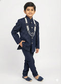 Child wearing a traditional navy blue outfit with a patterned jacket and matching pants on a white background