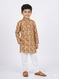 Child wearing a patterned kurta with white pants on a white background