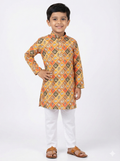 Child wearing a patterned kurta with white pants on a white background