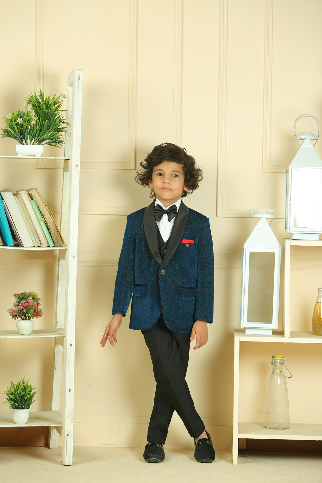 Child in a formal outfit standing in a room with shelves and decor
