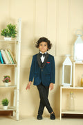 Child in a formal outfit standing in a room with shelves and decor