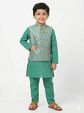 Young boy wearing a green traditional outfit with a patterned vest on a white background
