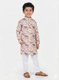 Child wearing a colorful kurta with white pants on a light gray background