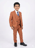Young boy wearing a brown suit with a white shirt and blue tie on a white background