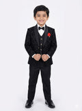 Young boy in a black tuxedo with a red handkerchief on a white background
