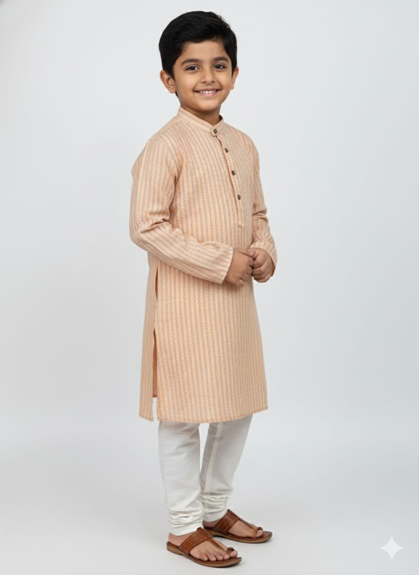 Young boy wearing a beige kurta with white pants on a light gray background