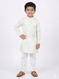 Young boy wearing a white kurta with white pants on a white background