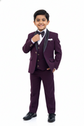 Young boy in a formal purple suit with a white shirt and black bow tie on a white background