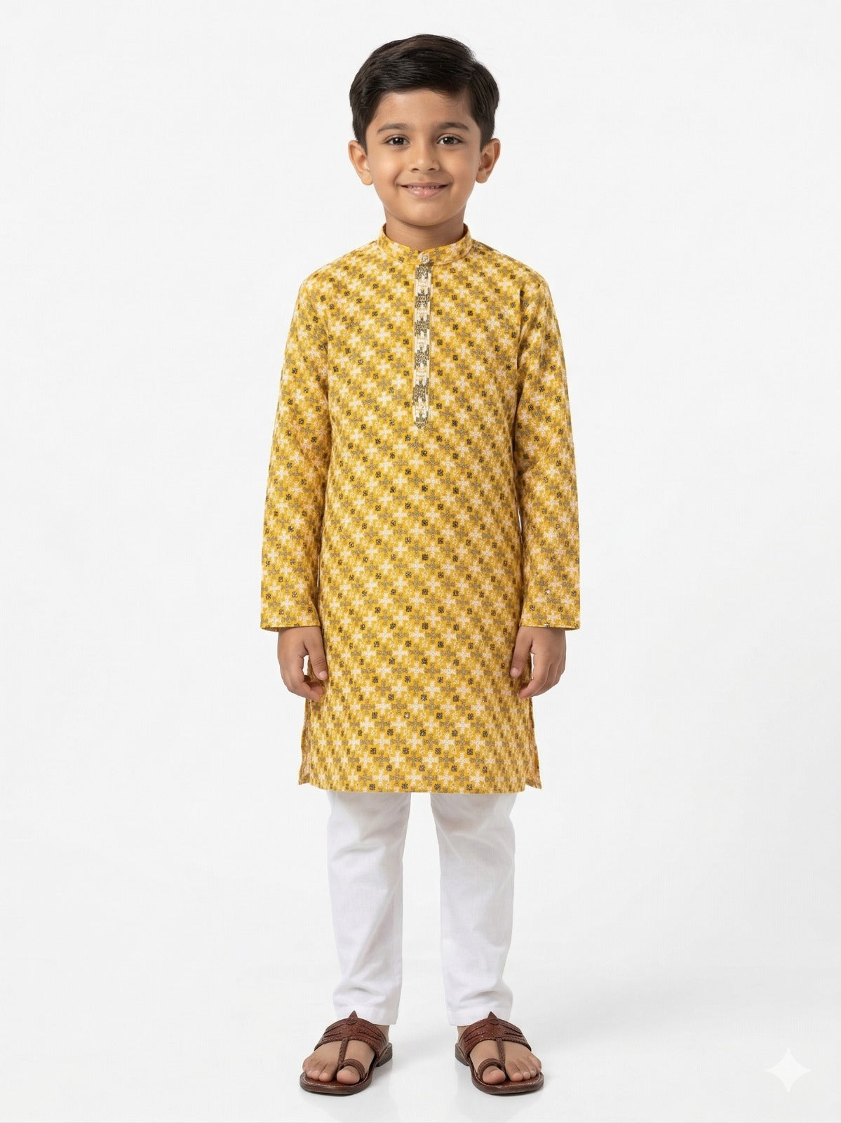 Young boy wearing a yellow kurta with white pants on a white background